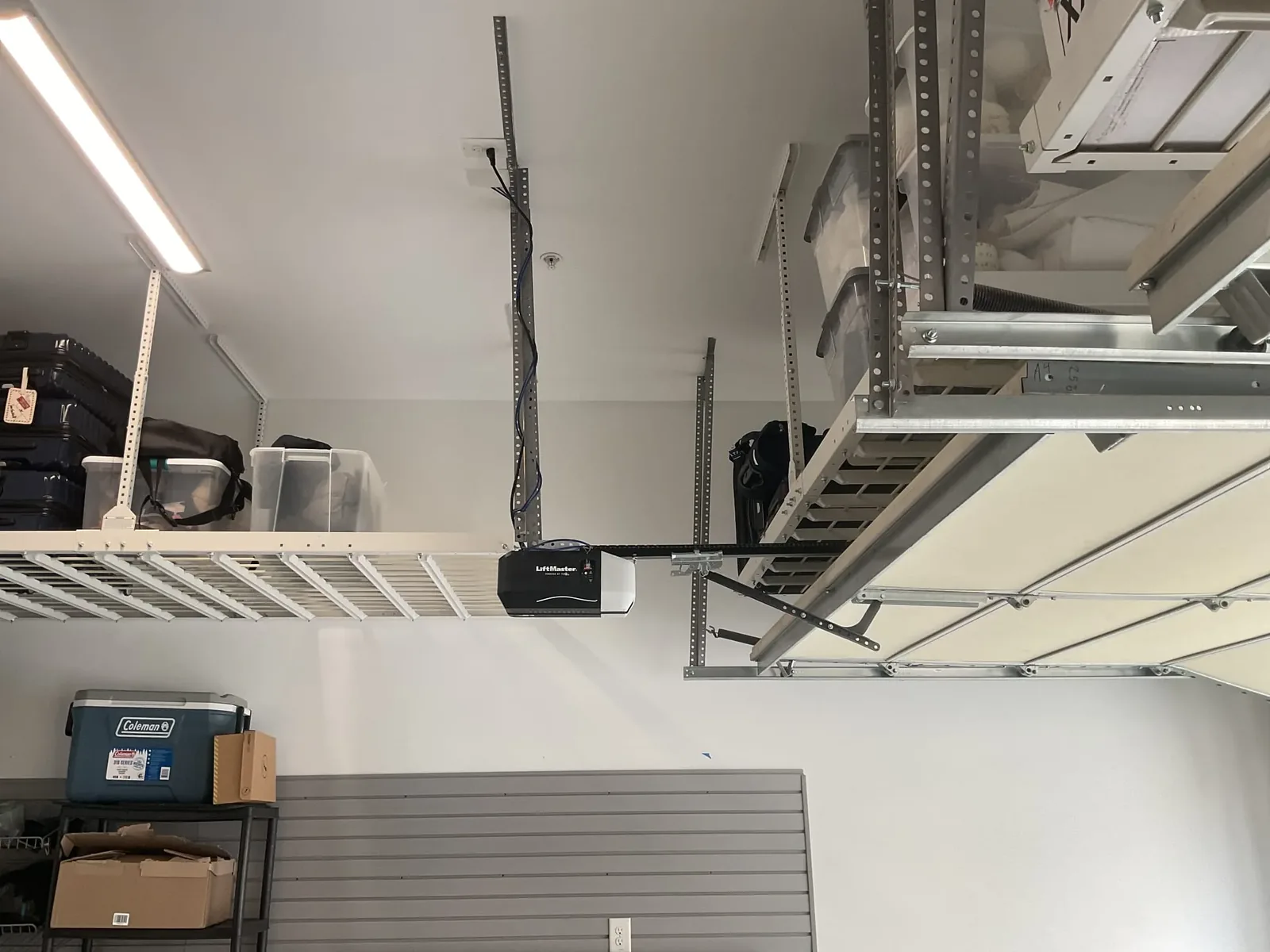 Newly installed belt-drive garage door opener on a garage ceiling